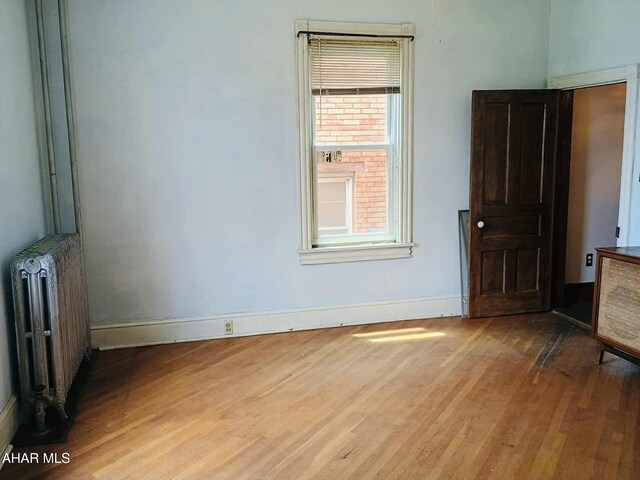 818 5th Ave, Patton, PA 16668 - unfurnished bedroom with radiator heating unit and wood finished floors