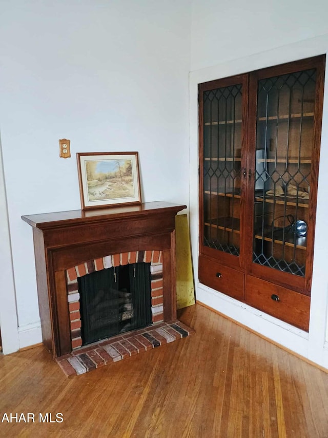 818 5th Ave, Patton, PA 16668 - detailed view of wood finished floors and a brick fireplace