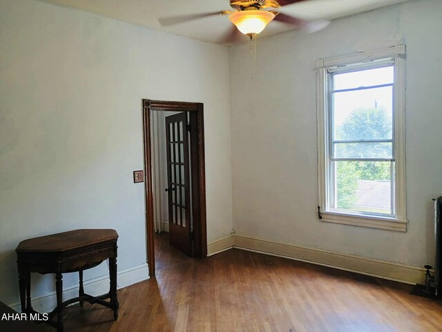 818 5th Ave, Patton, PA 16668 - empty room with a ceiling fan, healthy amount of natural light, and wood finished floors