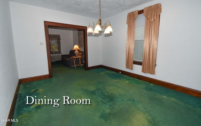 empty room featuring dark carpet, a textured ceiling, and an inviting chandelier