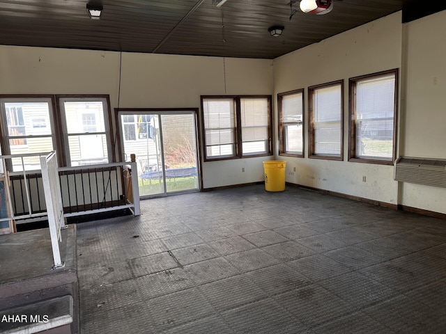 unfurnished sunroom featuring wooden ceiling