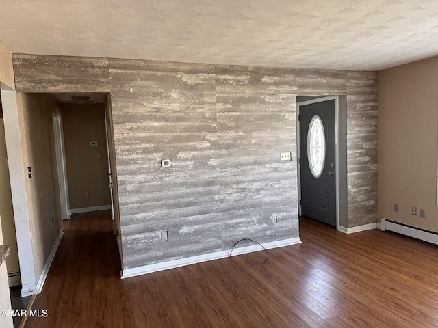 entryway featuring a textured ceiling, dark hardwood / wood-style floors, and a baseboard radiator