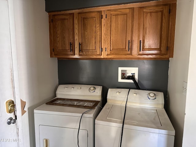 washroom featuring washer and dryer and cabinets