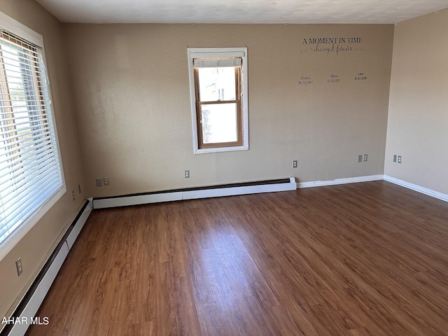 spare room with hardwood / wood-style floors and baseboard heating