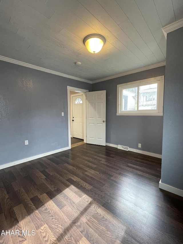 spare room featuring dark hardwood / wood-style floors and ornamental molding