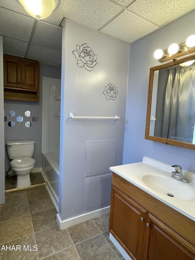 full bathroom featuring a paneled ceiling, vanity,  shower combination, and toilet