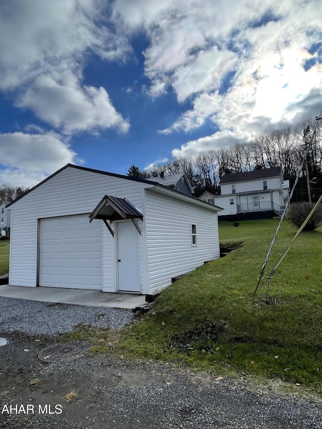 garage featuring a lawn