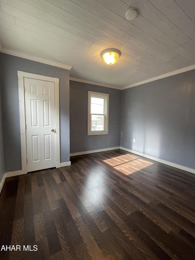 spare room with dark hardwood / wood-style floors and crown molding