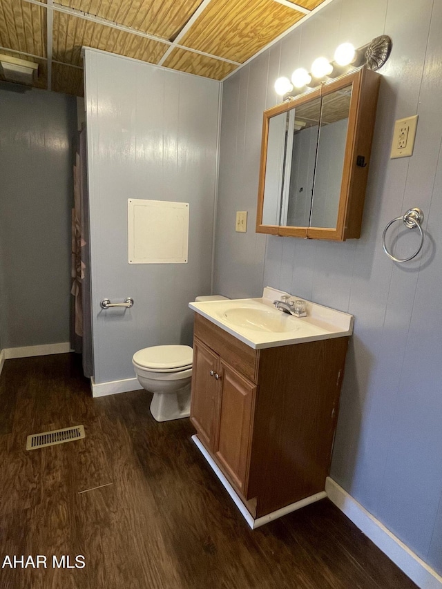 bathroom featuring vanity, toilet, wood-type flooring, and wood ceiling