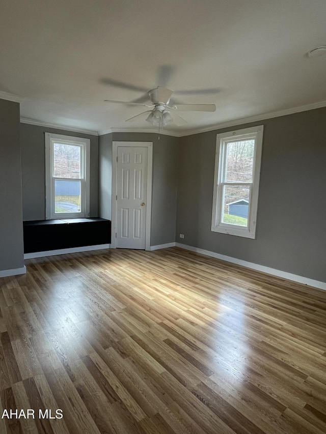 empty room with hardwood / wood-style floors, ceiling fan, and ornamental molding