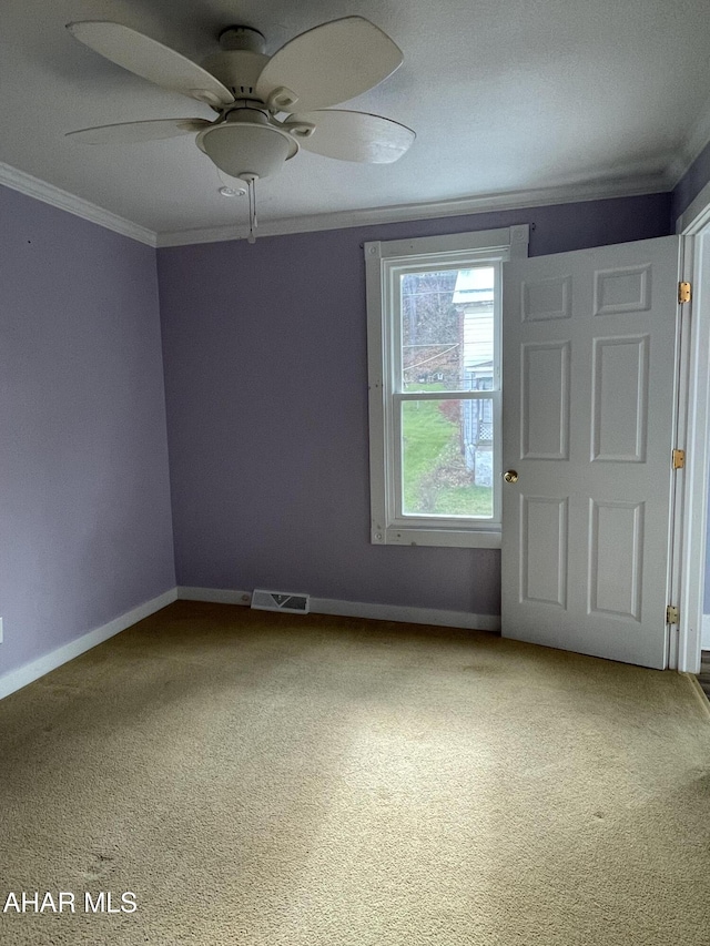 unfurnished room with carpet floors, ceiling fan, and ornamental molding