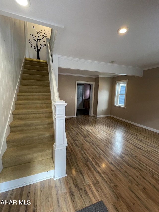 stairs featuring wood-type flooring and wood walls