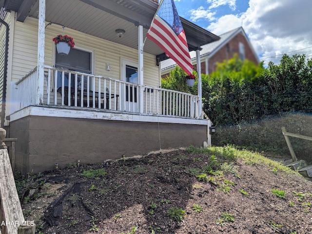 view of side of property with a porch