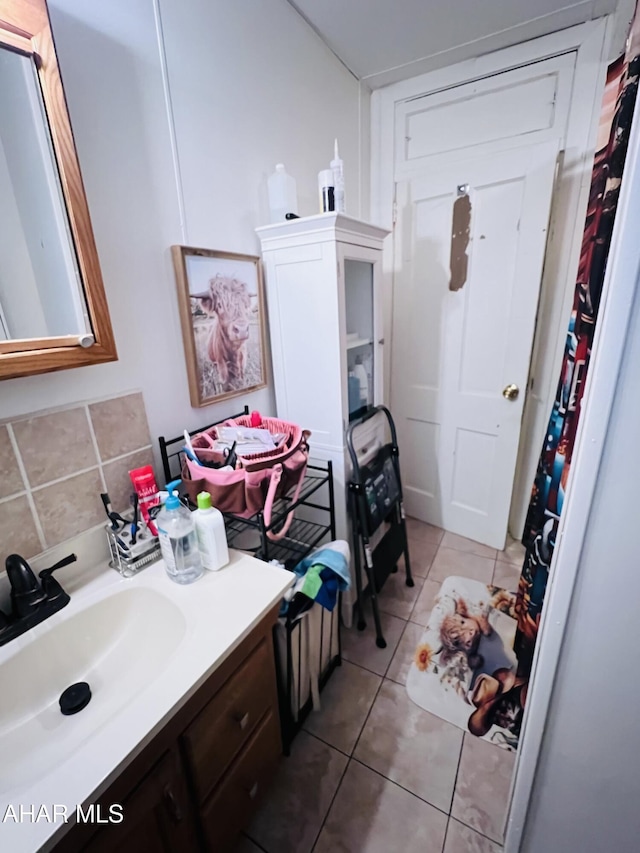 bathroom featuring tasteful backsplash, tile patterned floors, and vanity