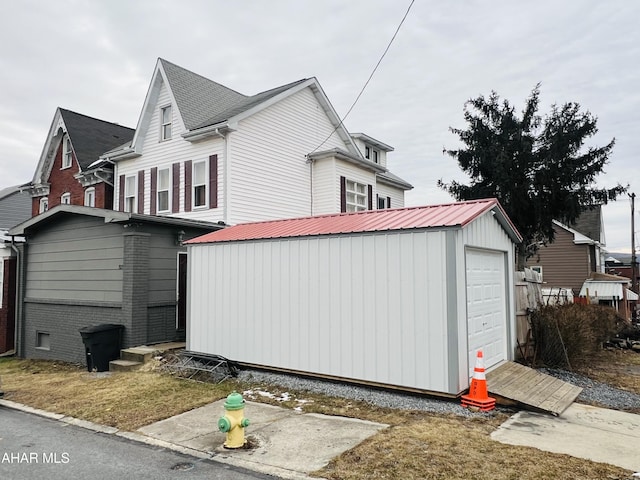 view of home's exterior featuring a garage and an outdoor structure