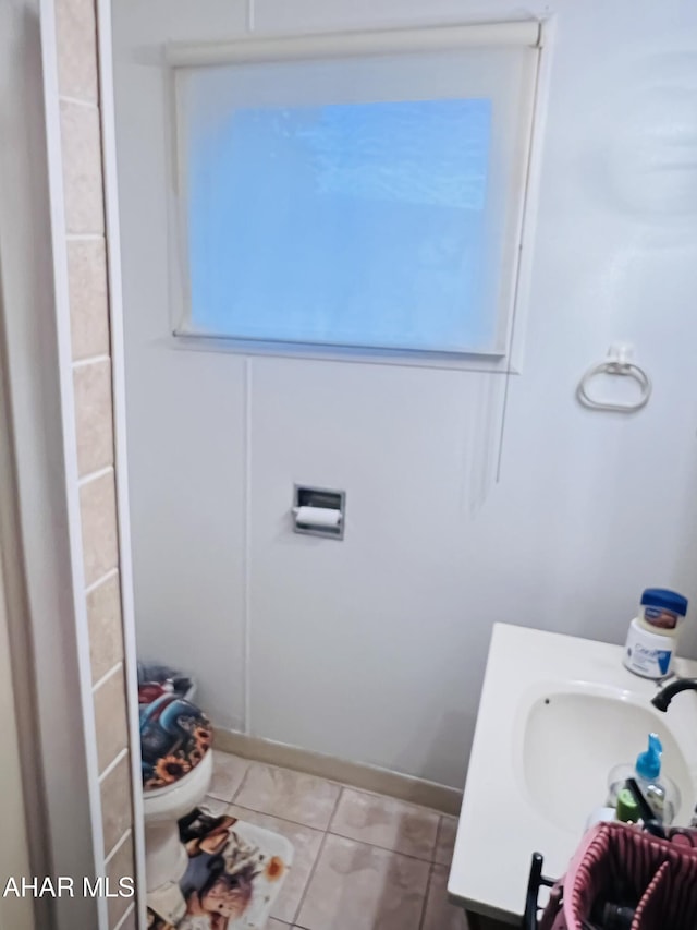 bathroom with sink, tile patterned floors, and toilet