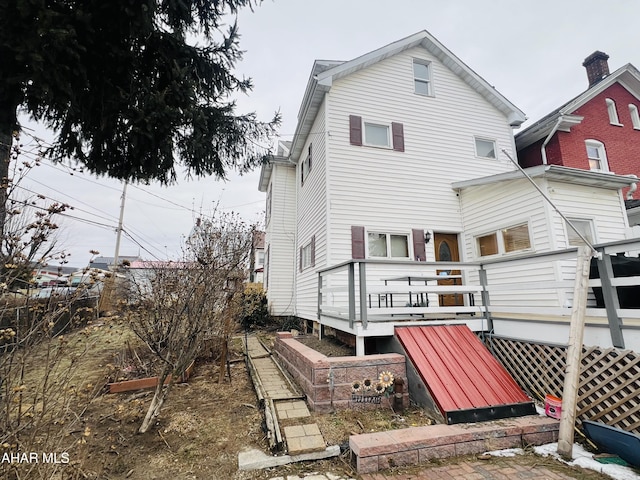 back of property featuring a deck