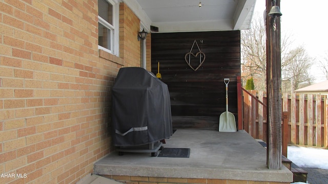 exterior space with fence and brick siding