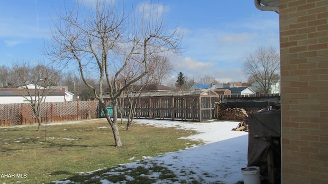 yard covered in snow featuring a fenced backyard