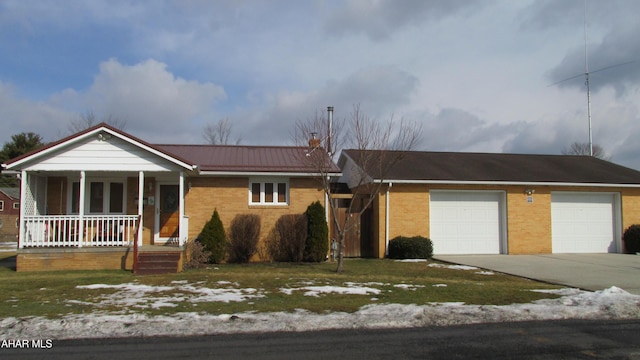 ranch-style house with driveway, a chimney, metal roof, a porch, and brick siding