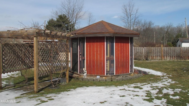 view of outbuilding featuring fence