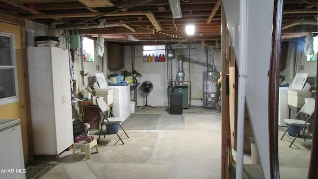 basement with washer and clothes dryer and gas water heater