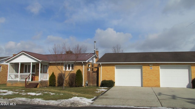 ranch-style house with brick siding, a chimney, covered porch, concrete driveway, and a garage