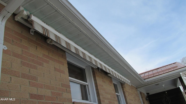 exterior details featuring brick siding