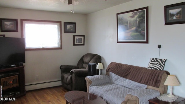 living area with ceiling fan, baseboard heating, and wood finished floors