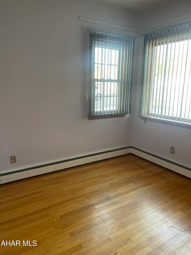 spare room with light hardwood / wood-style floors and baseboard heating