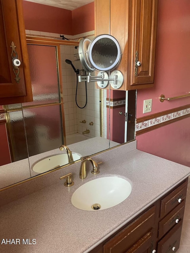 bathroom featuring enclosed tub / shower combo and vanity