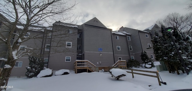 view of snow covered back of property