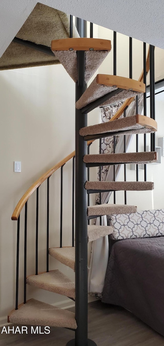 staircase with wood-type flooring