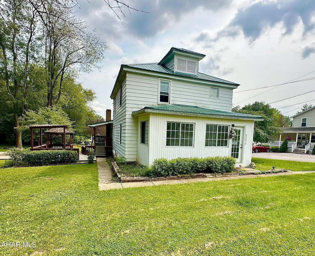 view of property exterior featuring a wooden deck and a yard