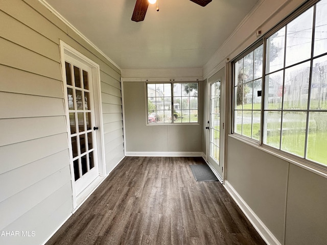 unfurnished sunroom with ceiling fan