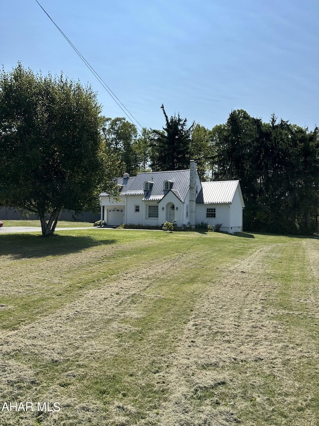 view of front facade with a garage and a front lawn