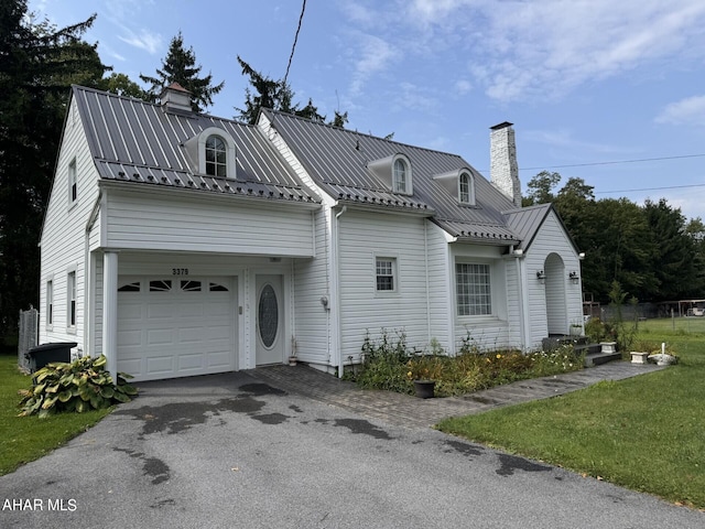 view of front of house featuring a garage and a front lawn