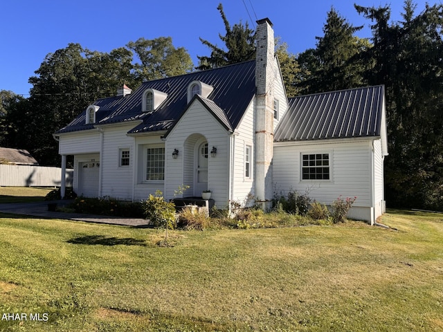 view of front of property with a front yard and a garage