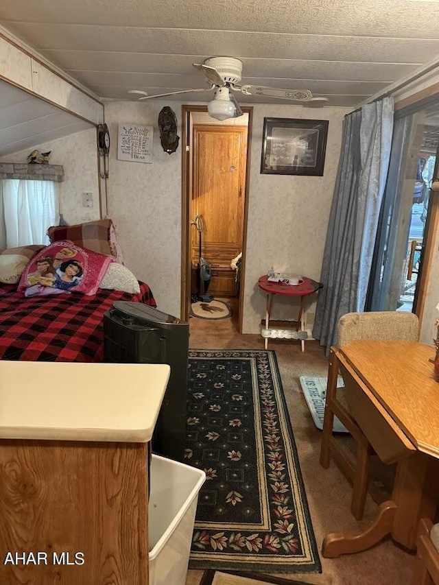 bedroom with carpet floors and vaulted ceiling