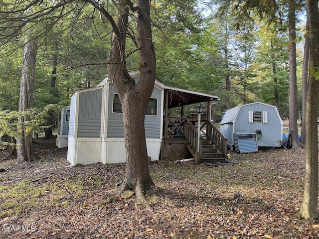 view of side of home with a shed