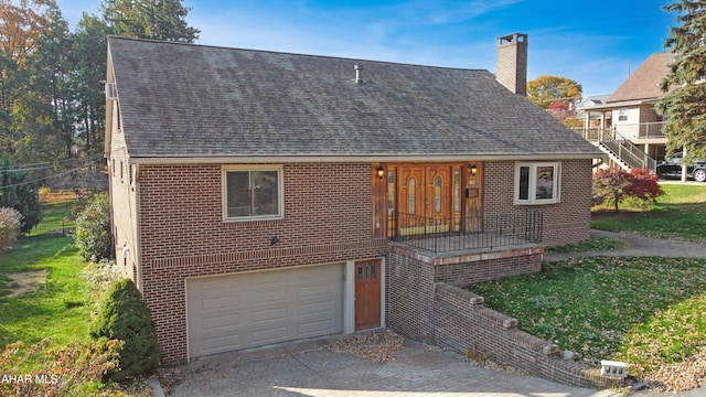 view of front of home with a front yard and a garage