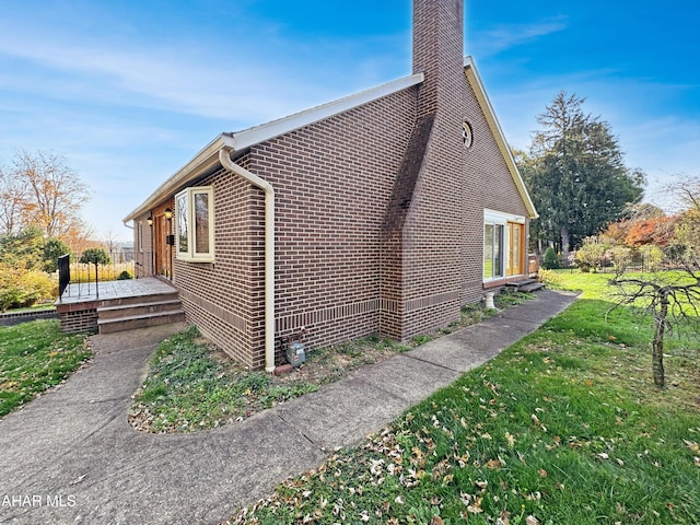 view of home's exterior with a yard