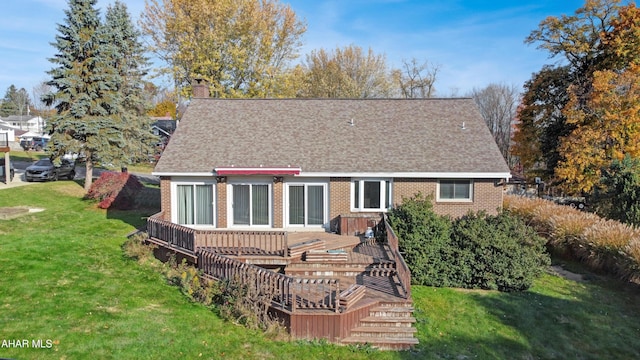 rear view of property with a lawn and a deck