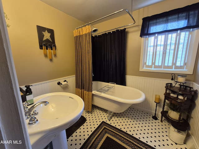 605 13th St, Duncansville, PA 16635 - full bathroom featuring a soaking tub, wainscoting, and curtained shower