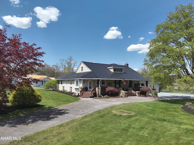 605 13th St, Duncansville, PA 16635 - country-style home with a porch, a chimney, metal roof, and a front yard