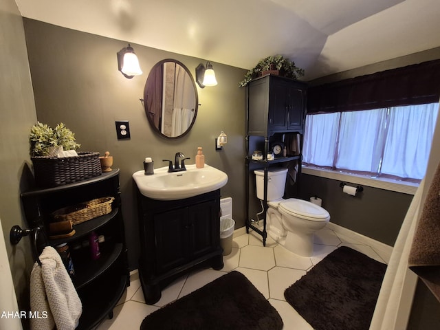 605 13th St, Duncansville, PA 16635 - bathroom with tile patterned flooring, vaulted ceiling, vanity, baseboards, and toilet