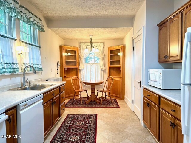 132 S Thomas St, Bedford, PA 15522 - kitchen featuring white appliances, healthy amount of natural light, a chandelier, a textured ceiling, and light countertops