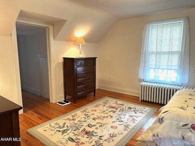 132 S Thomas St, Bedford, PA 15522 - bedroom featuring radiator heating unit, wood finished floors, and lofted ceiling