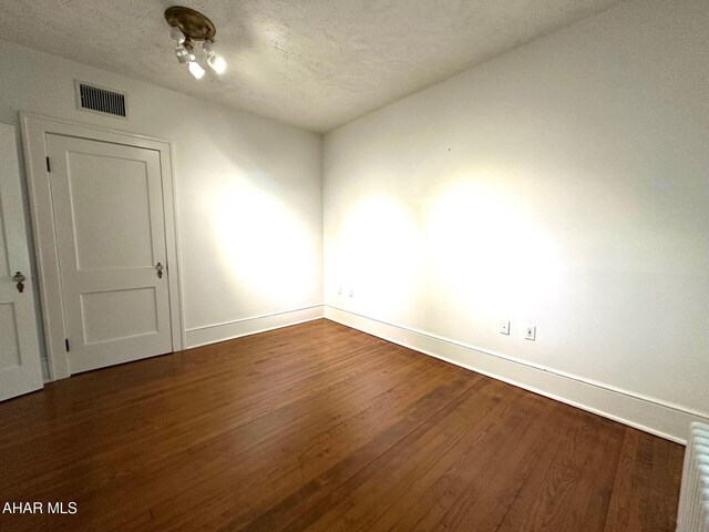 132 S Thomas St, Bedford, PA 15522 - unfurnished room featuring dark wood-type flooring and a textured ceiling