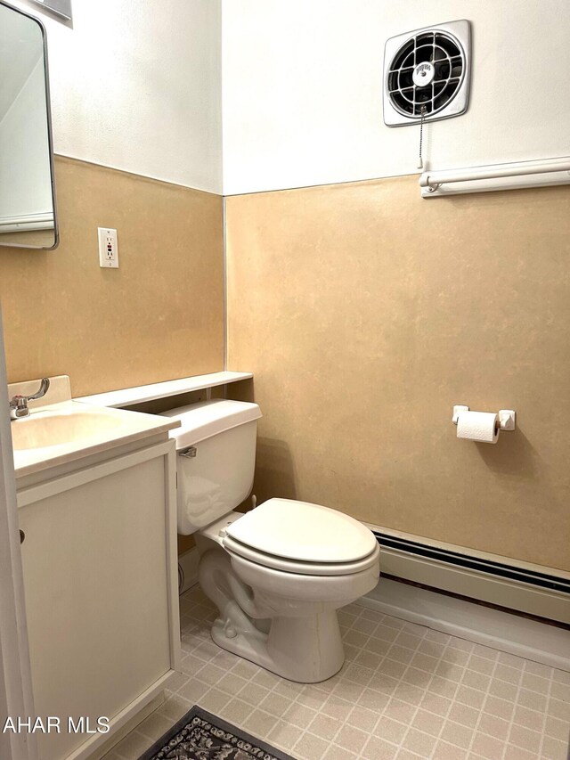 132 S Thomas St, Bedford, PA 15522 - half bath featuring baseboard heating, vanity, and tile patterned flooring